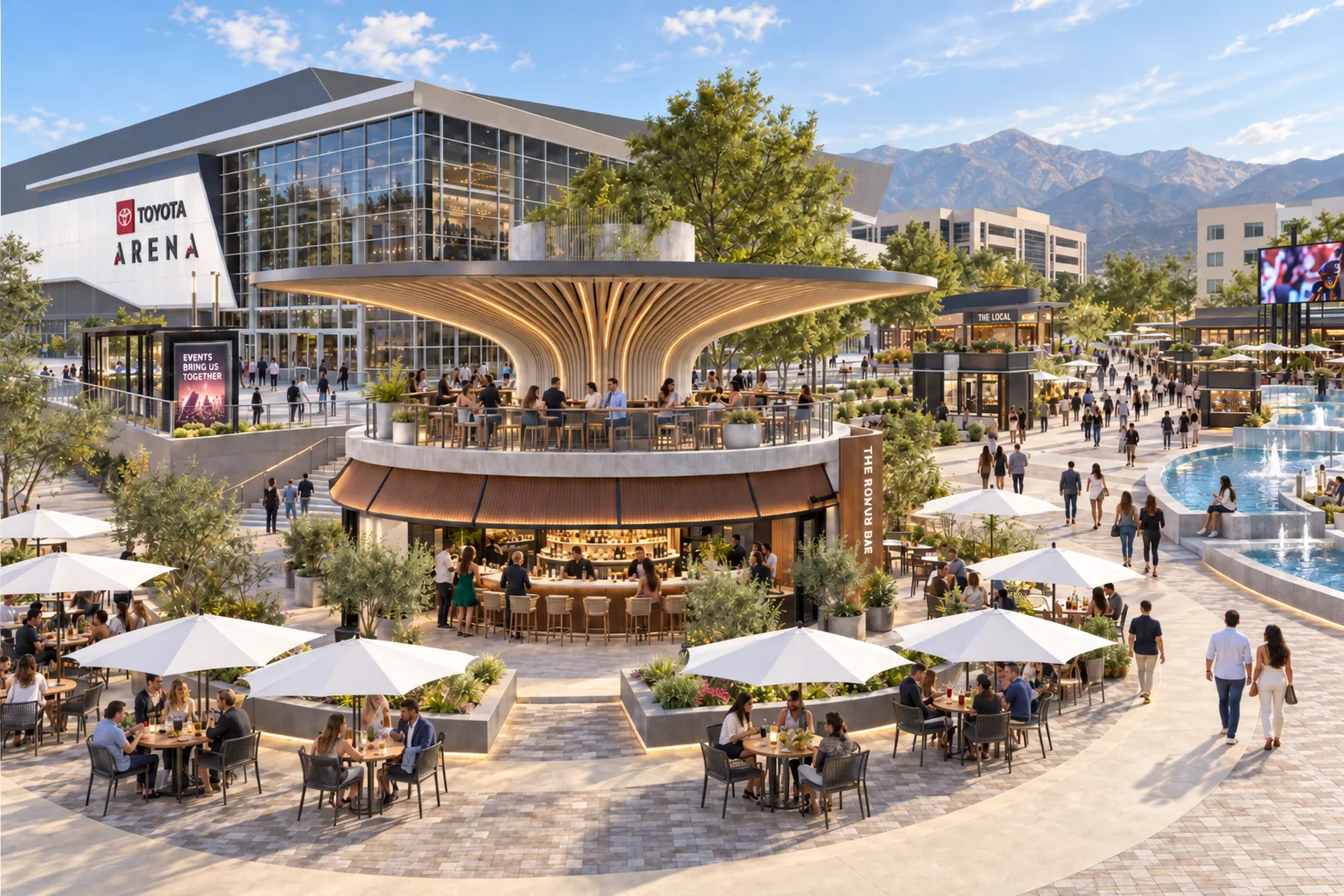 The Round Bar on the Plaza by day: patios under white umbrellas, Toyota Arena behind and the mountains beyond